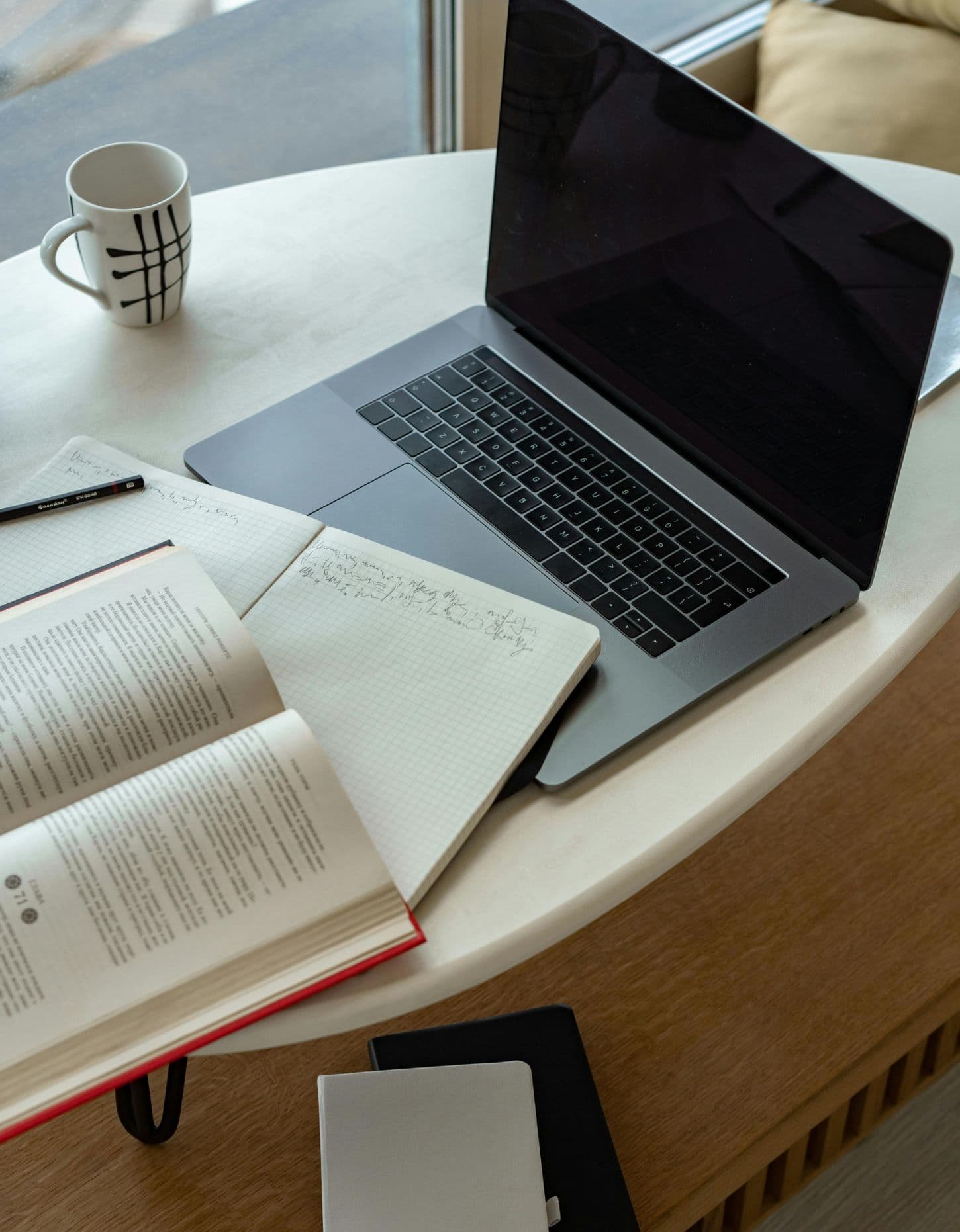 Laptop and notebook on table