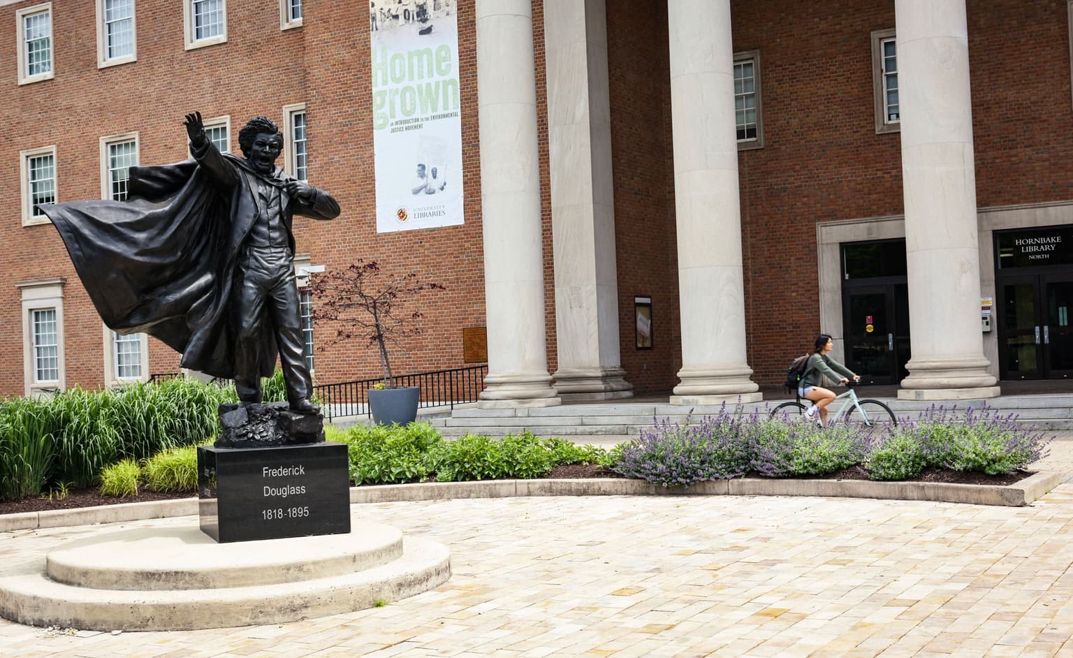 Statue on campus and person on bike
